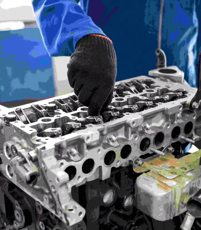 Mechanic servicing car engine parts - genuine auto parts specialist